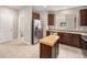 Bright kitchen featuring stainless steel appliances, brown cabinetry, tile floors, and a butcher block island at 11250 Florence St # 29D, Commerce City, CO 80640