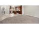 Open floor plan with tiled flooring leading to a modern kitchen with stainless steel appliances and island at 11250 Florence St # 29D, Commerce City, CO 80640