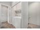 Laundry room with a washer and dryer, a shelf, and access to the staircase at 11250 Florence St # 29D, Commerce City, CO 80640