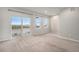 Living room with ample natural light with three windows and a sliding door to the outdoor balcony at 11250 Florence St # 29D, Commerce City, CO 80640