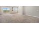 Bright living room with neutral carpet, multiple windows and a sliding door to a small balcony at 11250 Florence St # 29D, Commerce City, CO 80640