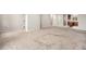 Expansive living area seamlessly connecting the carpeted living room with the modern kitchen at 11250 Florence St # 29D, Commerce City, CO 80640
