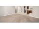 Open-concept living space with carpet flooring flowing into a kitchen featuring modern stainless steel appliances at 11250 Florence St # 29D, Commerce City, CO 80640