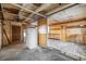 Unfinished basement with refrigerator and partial walls at 7121 W 52Nd Ave, Arvada, CO 80002