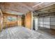 Unfinished basement area with a refrigerator and shelving at 7121 W 52Nd Ave, Arvada, CO 80002