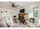 Cozy living room featuring a fireplace and ample natural light at 7121 W 52Nd Ave, Arvada, CO 80002