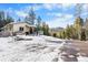 House exterior showcasing snowy landscape and mountain views at 8340 London Ln, Conifer, CO 80433