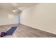 Finished basement space with a yoga mat, purple yoga blocks, ceiling fan, and light wood floors at 4221 S Blackhawk Cir # 7G, Aurora, CO 80014