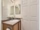 Bathroom sink vanity with cabinets, a mirror, and lighting at 4221 S Blackhawk Cir # 7G, Aurora, CO 80014