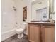 Bathroom featuring a shower-tub combo and a vanity with wooden cabinets at 4221 S Blackhawk Cir # 7G, Aurora, CO 80014