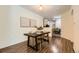 Dining area featuring a modern table setting, stylish chairs, wood-look floors, and contemporary artwork at 4221 S Blackhawk Cir # 7G, Aurora, CO 80014