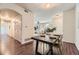 Dining room with modern dark wood table, gold chairs, and view to living room at 4221 S Blackhawk Cir # 7G, Aurora, CO 80014