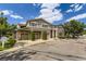 Townhouse exterior featuring stone accents, attached garages, manicured greenery, and well-maintained landscaping at 4221 S Blackhawk Cir # 7G, Aurora, CO 80014