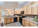 Well-lit kitchen featuring oak cabinets, black appliances, and a functional layout at 4221 S Blackhawk Cir # 7G, Aurora, CO 80014