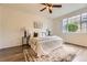 Bright main bedroom with a ceiling fan, modern decor, and a large window at 4221 S Blackhawk Cir # 7G, Aurora, CO 80014