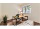 Bright office space featuring a modern desk, neutral walls and ample natural light from a large window at 4221 S Blackhawk Cir # 7G, Aurora, CO 80014