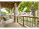 Inviting front porch with stone accents, wood trim, wood railing, and seating area at 4221 S Blackhawk Cir # 7G, Aurora, CO 80014