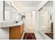 Bathroom featuring double vanity, walk in closet, mirrors and bright neutral colors at 475 W 12Th Ave # 9A, Denver, CO 80204