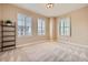 Bright bedroom featuring neutral walls, plush carpet, and bright light from three shuttered windows at 475 W 12Th Ave # 9A, Denver, CO 80204
