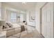 Bright main bedroom featuring a tray ceiling, decorative shutters, and soft decor at 475 W 12Th Ave # 9A, Denver, CO 80204