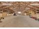 Spacious barn with open riding area, stalls, and truck at 1641 Castlewood Dr, Franktown, CO 80116