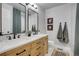 Elegant bathroom with double vanity and large mirrors at 1641 Castlewood Dr, Franktown, CO 80116