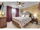 Cozy bedroom with wood-paneled wall and rustic decor at 1641 Castlewood Dr, Franktown, CO 80116