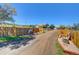 Long gravel driveway leads to a charming ranch home with rustic accents at 1641 Castlewood Dr, Franktown, CO 80116