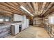 Barn tack room with cabinets, refrigerator, and rustic wood at 1641 Castlewood Dr, Franktown, CO 80116