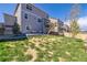 Spacious backyard with a well-maintained lawn, patio, and stairs leading to upper level at 17341 Red Cosmos Pt, Parker, CO 80134