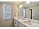 Elegant bathroom featuring double sinks, quartz countertops, and bright lighting at 17341 Red Cosmos Pt, Parker, CO 80134