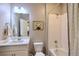 Clean bathroom with a shower/tub combo, white vanity, and decorative artwork at 17341 Red Cosmos Pt, Parker, CO 80134