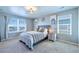 Bright bedroom with soft carpet, many windows, and lion decor at 17341 Red Cosmos Pt, Parker, CO 80134