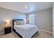 Cozy bedroom featuring a comfortable bed, bedside table, and neutral decor at 17341 Red Cosmos Pt, Parker, CO 80134