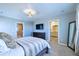 Bedroom featuring a TV, dresser, access to an ensuite bath and cozy bedding at 17341 Red Cosmos Pt, Parker, CO 80134