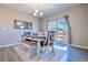 Dining area with a modern table and chairs, a large mirror, and sliding glass doors to the outside at 17341 Red Cosmos Pt, Parker, CO 80134