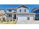 Charming two-story home featuring a covered front porch, three-car garage, and well-maintained landscaping at 17341 Red Cosmos Pt, Parker, CO 80134