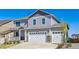 Beautiful two-story home with a three-car garage, classic architectural details, and manicured front yard at 17341 Red Cosmos Pt, Parker, CO 80134