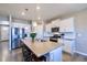 Spacious kitchen with white cabinets, stainless steel appliances, large kitchen island with seating at 17341 Red Cosmos Pt, Parker, CO 80134
