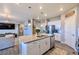 Bright, open kitchen featuring white cabinets, stainless appliances, with a large island and lots of space at 17341 Red Cosmos Pt, Parker, CO 80134