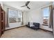 Bright bedroom featuring neutral walls, carpet, and multiple windows providing lots of natural light at 6389 Umber Cir, Arvada, CO 80403