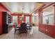 Elegant dining room with a large table, built-in shelving, and ample natural light at 6389 Umber Cir, Arvada, CO 80403