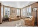 Comfortable living room with plush seating, natural light from the large windows, and neutral decor at 6389 Umber Cir, Arvada, CO 80403