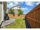 Backyard featuring a well-manicured lawn and privacy fence at 18372 E 100Th Pl, Commerce City, CO 80022