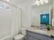 Modern bathroom featuring a shower-tub combo, granite countertop, and an adjacent bedroom view at 18372 E 100Th Pl, Commerce City, CO 80022