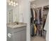 Bathroom with granite countertop, gray cabinets and walk-in closet at 18372 E 100Th Pl, Commerce City, CO 80022