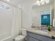 Bright bathroom featuring a shower-tub, granite countertop, and adjacent bedroom view at 18372 E 100Th Pl, Commerce City, CO 80022