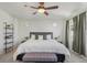 Main bedroom features a ceiling fan, large bed, accent pillows, and ambient lighting at 18372 E 100Th Pl, Commerce City, CO 80022