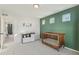 Comfortable Bedroom with a wood crib and changing table and a nice accent wall at 18372 E 100Th Pl, Commerce City, CO 80022