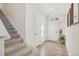 Bright entryway with stairs, wood-look floors, and coat closet at 18372 E 100Th Pl, Commerce City, CO 80022